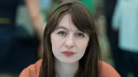 Sally Rooney states she cannot enter the UK due to arrest fears
